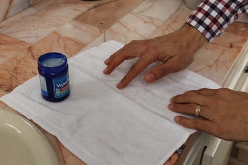 Applying essential oil to dry Towel.