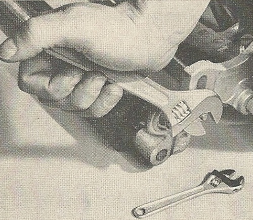 Vintage man using wrench close up. 