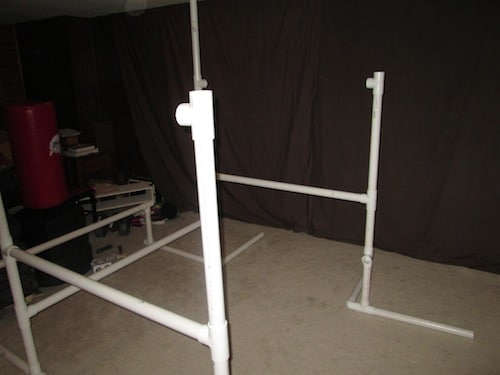 Step 13: Insert a two foot PVC pipe into the top of the T section and another T section on top of that. Make sure it is pointed inward.