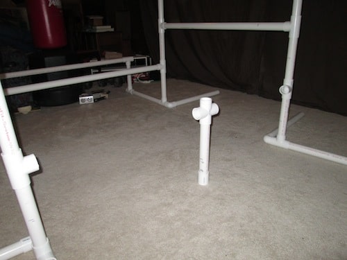 Step 20: Insert your 1 foot 1 inch PVC pipe into the cross section on one end and the other end into your one connector piece.