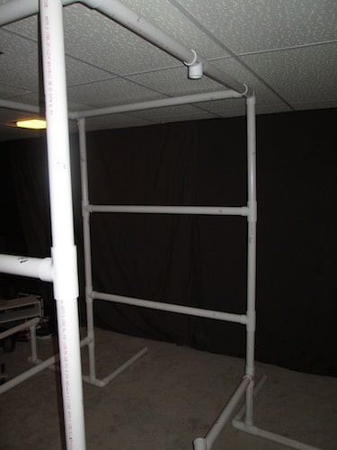 Step 22: Insert your 2 foot PVC pipe sections on both sides of your last open T sections and put another T section facing downward in between the 2 foot pipes.