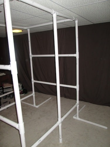 Step 23: Insert your 5 foot 3 1/2 inch PVC pipe vertically into the open T sections as shown below.