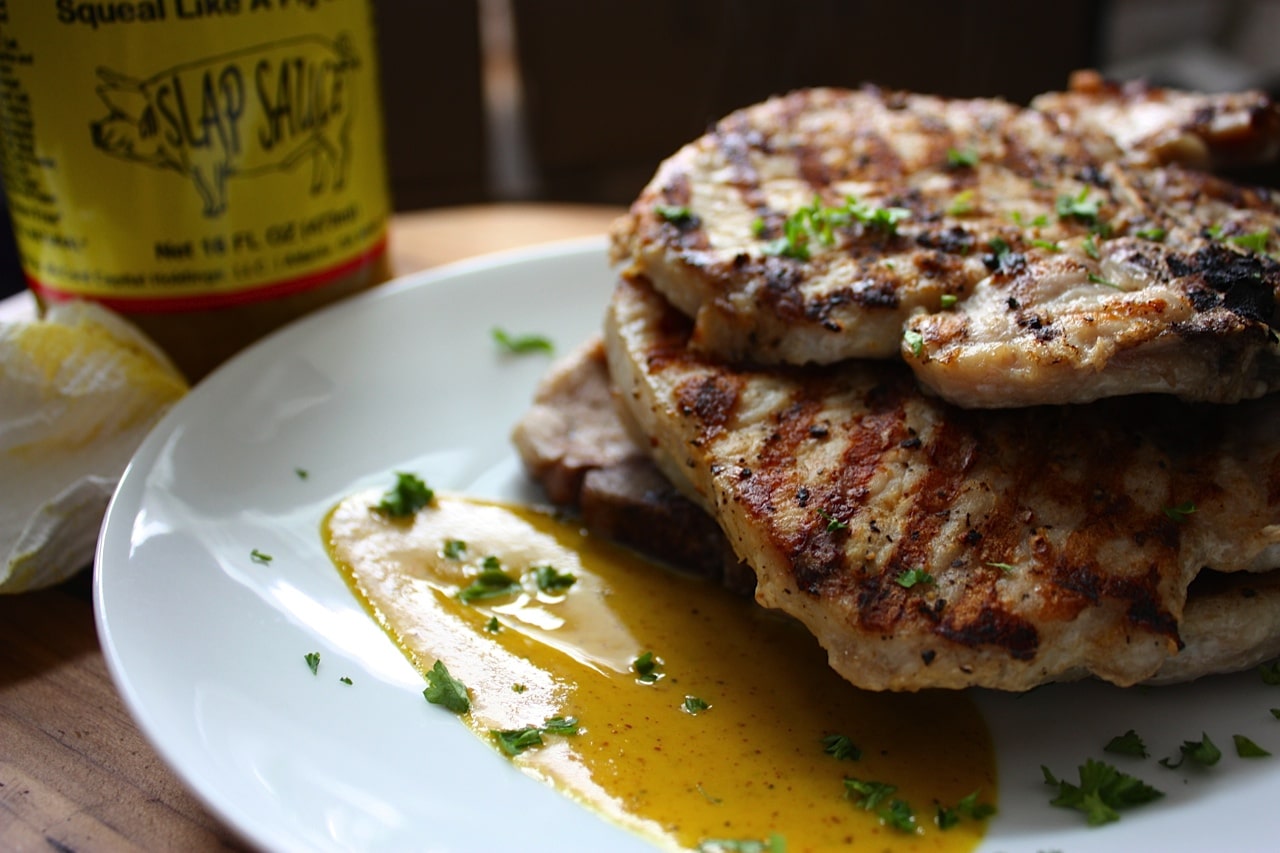 grilled pork chops on place with slap sauce BBQ.