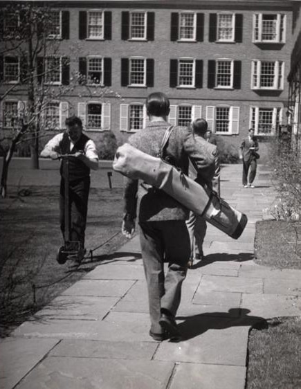 Vintage students walking on campus with books supplies.