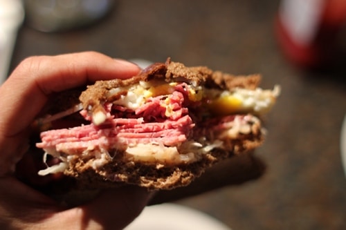 Vintage eating Reuben sandwich.