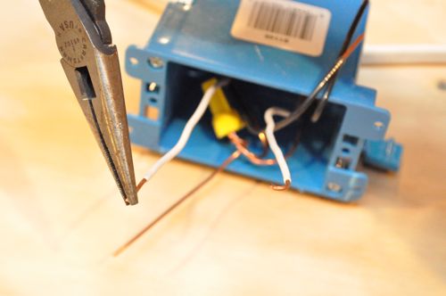 Using pliers or a loop-maker on the wire strippers, twist the exposed wire into a half-circle.