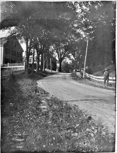 Vintage man walking along dirt road in the country. 