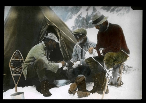 Vintage african black men mountaineers camping.