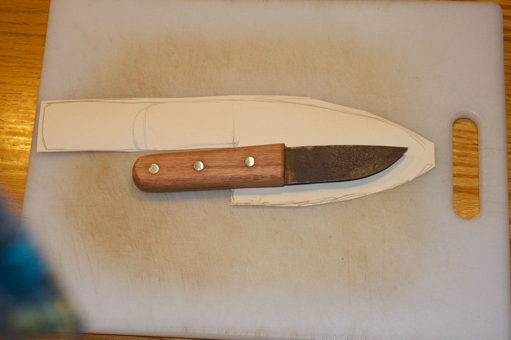 Vintage Homemade knife and rough cutting paper.