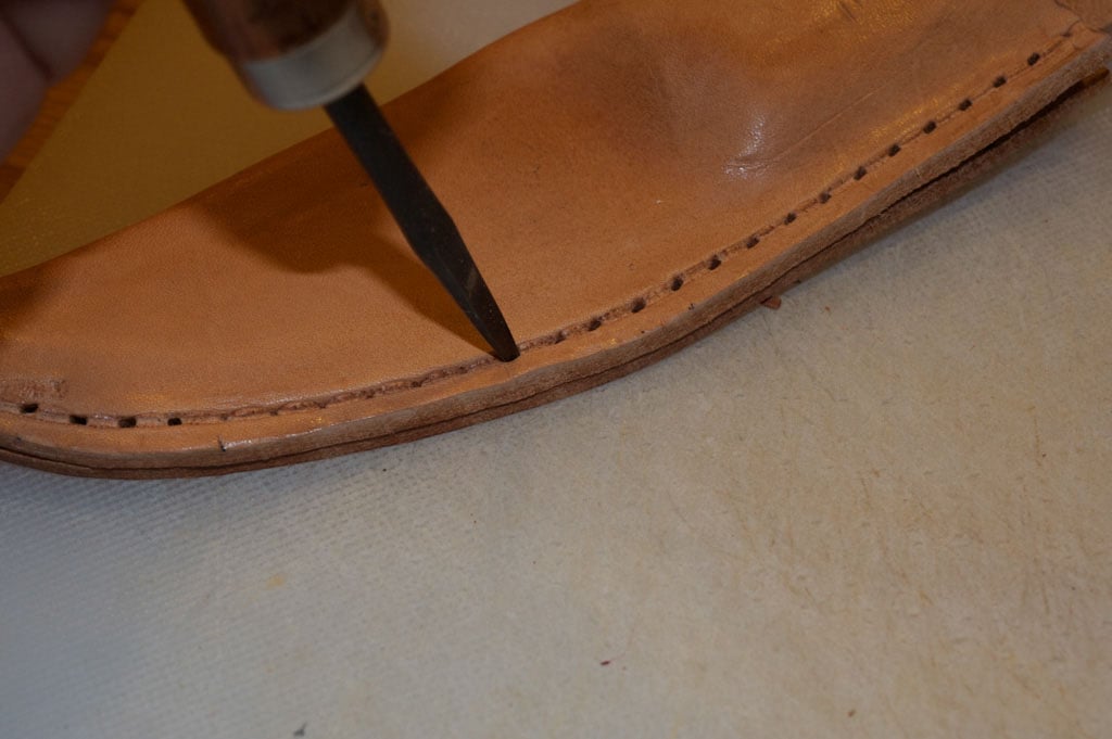 Vintage sheath on a plastic cutting board and using fid for create holes.