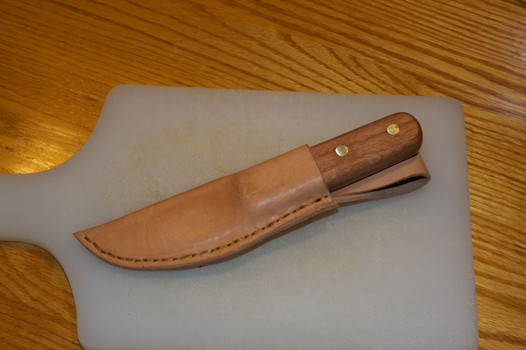 Vintage insert knife in the leather sheath.