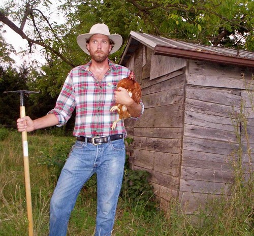 Forrest pritchard farmer with chicken in arms. 