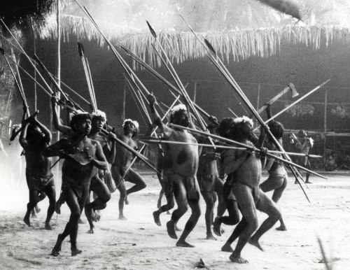 Yanomamo tribesman dancing with spears. 