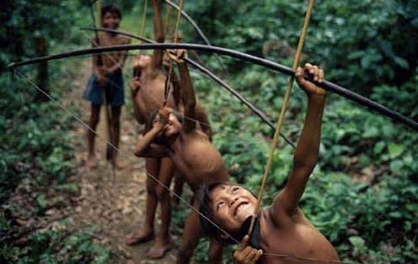 Yanomamo children boys training with bow and arrow.