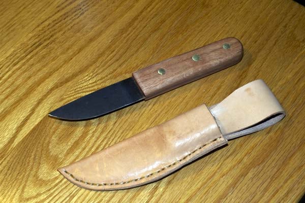 Homemade knife with leather sheath from saw blade.
