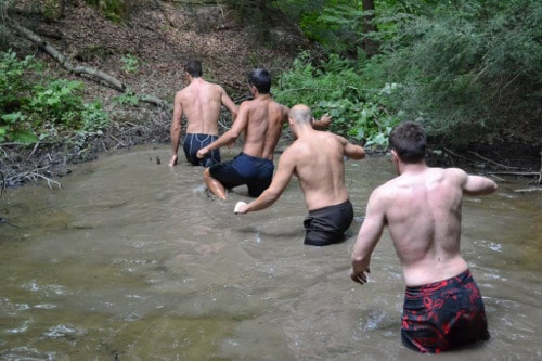 Vintage men walking in the water.