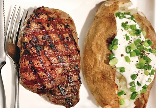 Homemade grilled filet mignon and baked potato sour cream and chives.