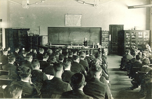 Vintage high school college classroom students listening to lecture.