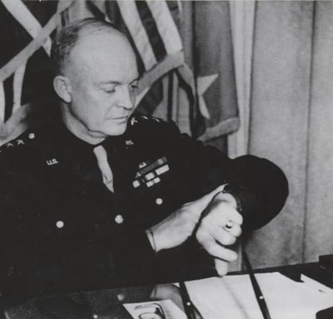 Dwight Ike Eisenhower in military uniform looking at watch.