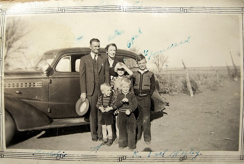 Vintage family with 4 kids standing in front of car 1920s 1930s.