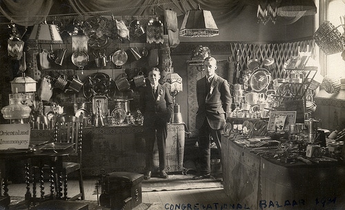 Vintage young businessmen standing in their store shop.