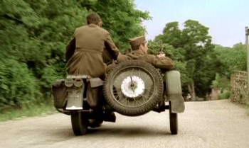 Soldiers in motorbike motorcycle with sidecar.