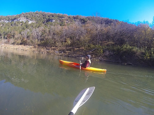 Man on kayak paddling down buffalo river Arkansas.