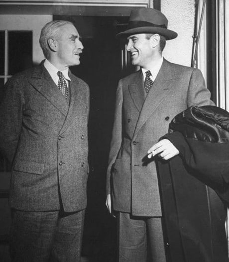 Vintage businessmen in suits meeting talking smiling.