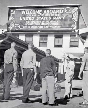 Vintage men looking up at navy sign welcome aboard us navy.