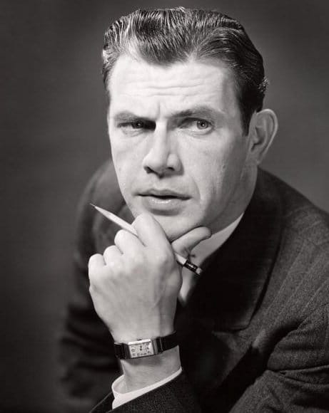 Vintage businessman with hand on chin looking intense focus.