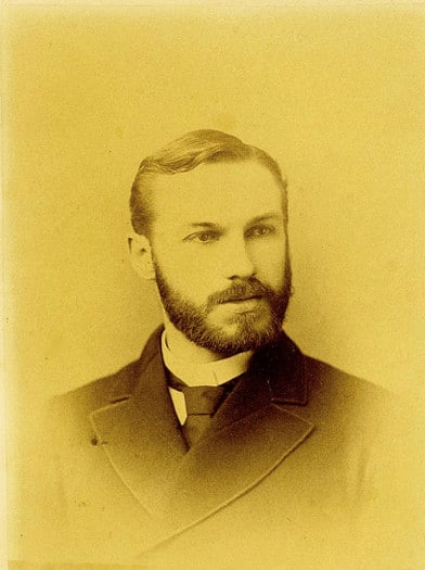 Vintage man with trimmed full beard portrait chest up.