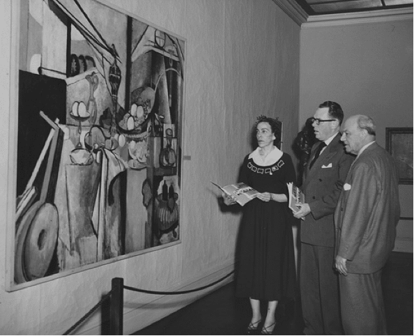 Vintage people in art museum looking at print painting.