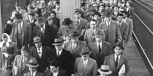 Vintage men at train station waiting on platform for trains.