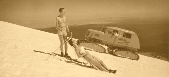 Vintage man and woman on ski slope sun bathing.