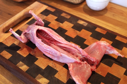 I typically do this inside and start by thoroughly washing the rabbit in the sink to clean off any remaining blood, hair, or debris from the field dressing process.