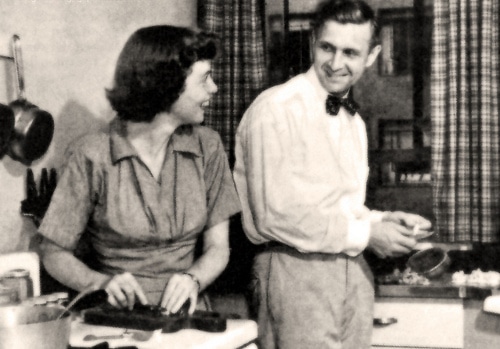 Vintage couple cooking in kitchen.