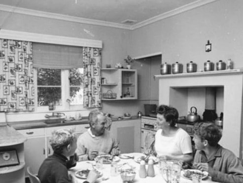 vintage family at dinner table in home 