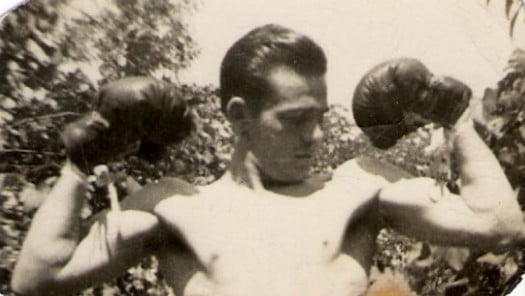 vintage man with boxing gloves on flexing biceps arms
