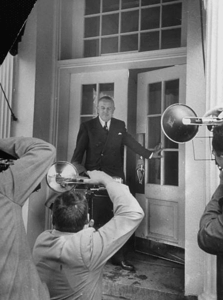 Vintage man enter in room with flashlight.