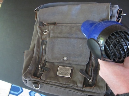 applying heat with hair dryer to diy waxed canvas bag