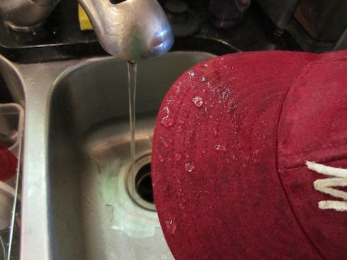 water dripping off diy waxed hat