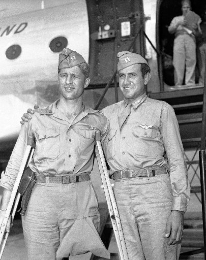 Louis Zamperini, Fred Garrett posing in uniform in front of plane