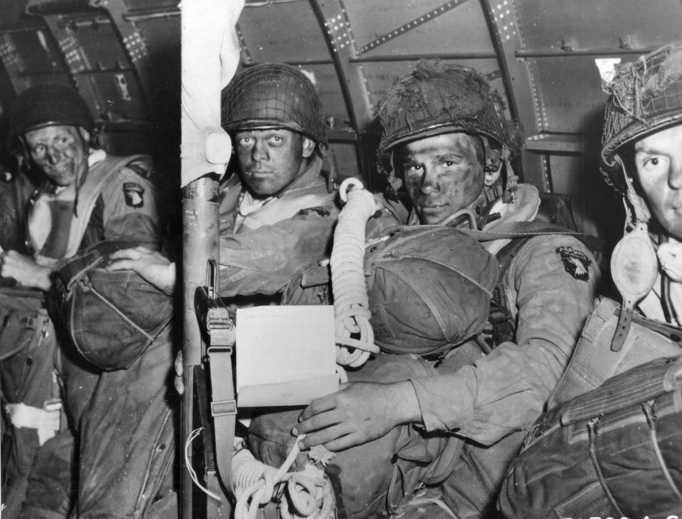 Vintage paratroopers in airplane camouflage paint on faces.