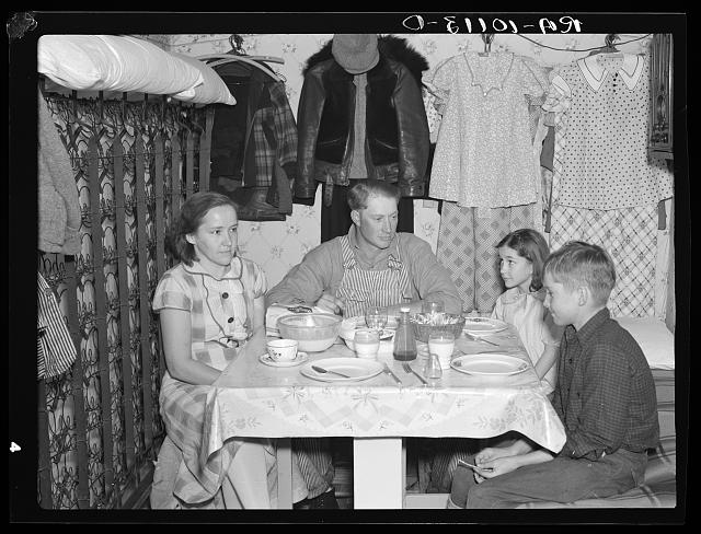 Vintage Great depression family eating dinner 1930s.