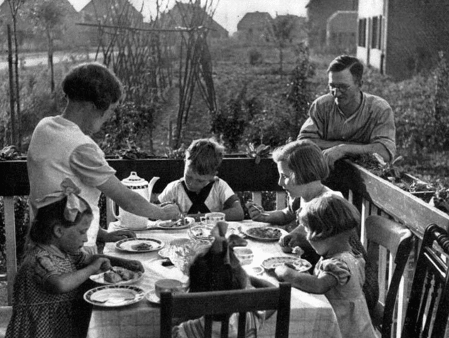 Vintage family eating dinner on table. 