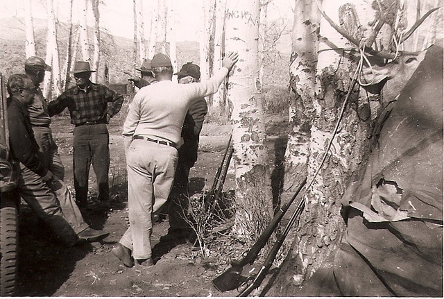Vintage hunters talking in forest. 