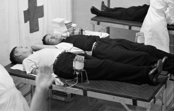 vintage men donating blood at american red cross