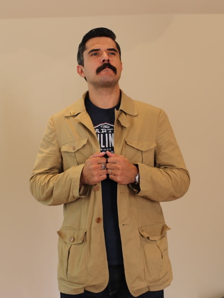 Man wearing a jacket of multiple pockets. 