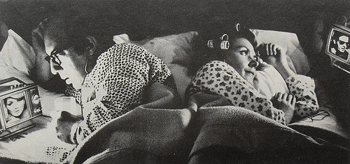 vintage couple in bed watching tv