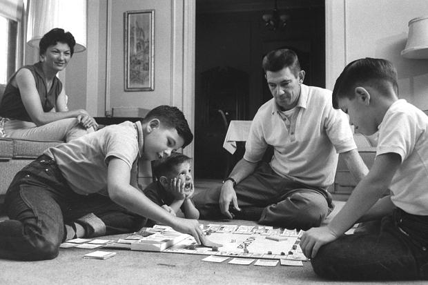 Vintage family playing board game on living Room Floor.